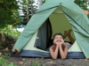 happy boy in camping tent